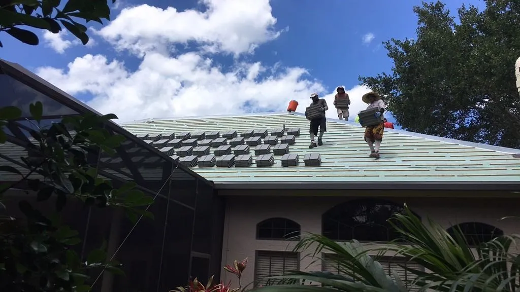 roofers on teal roof
