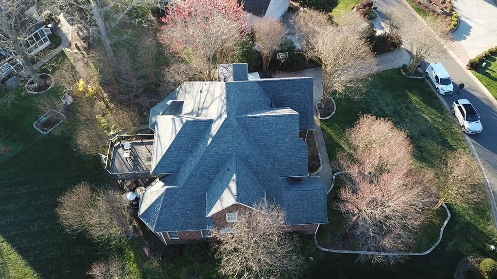 red brick house with blue roof aerial view